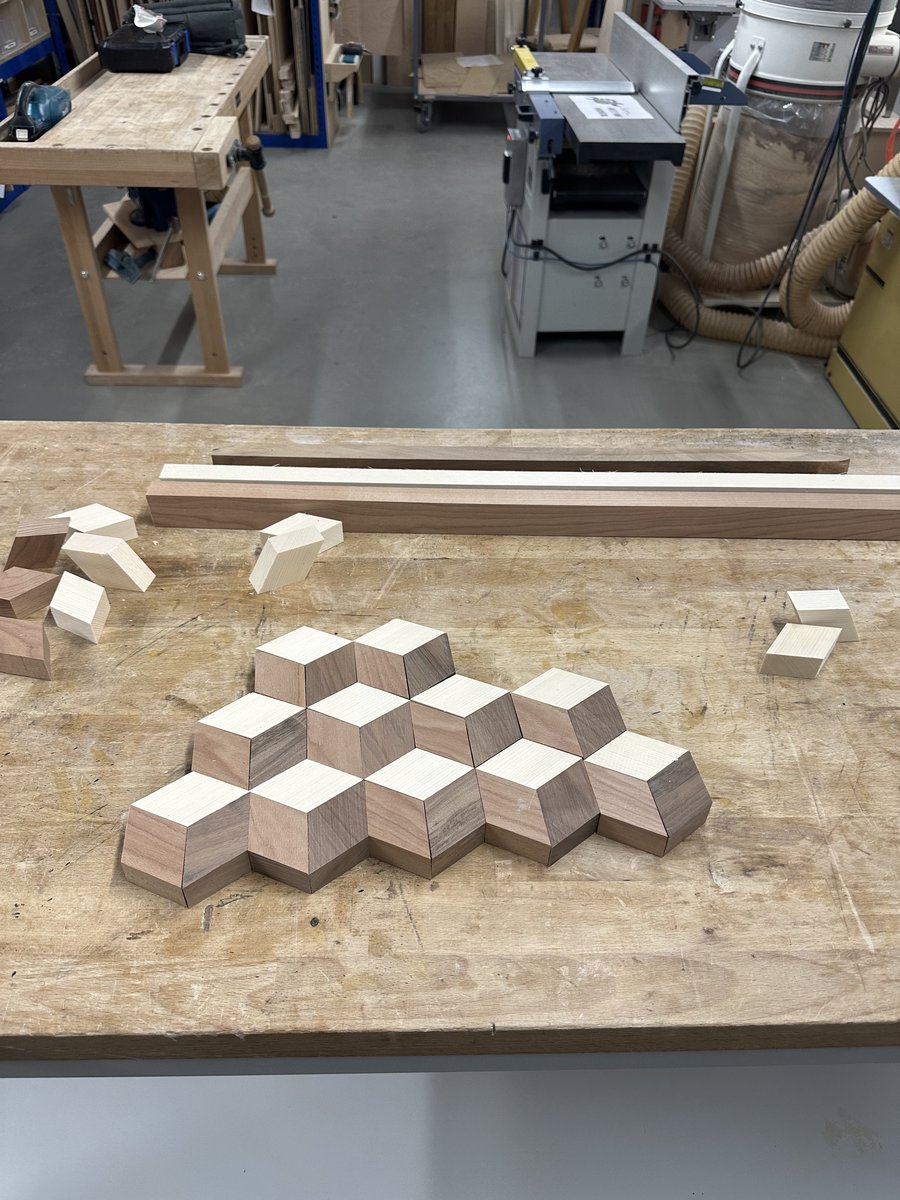 Dry-fit of alternating parallelogram strips revealing the tumbling cubes illusion