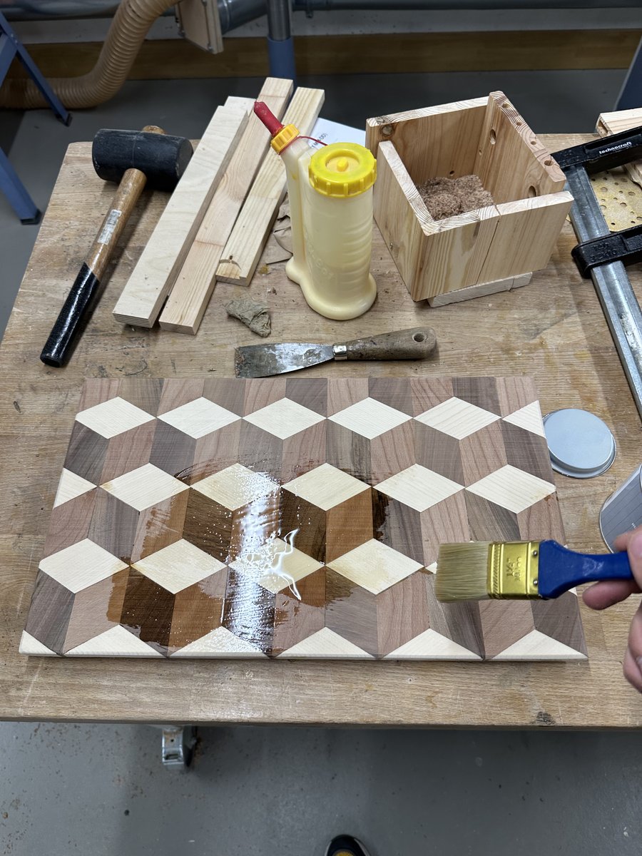 First brush stroke of mineral oil down the centerline of the 3D cubes board