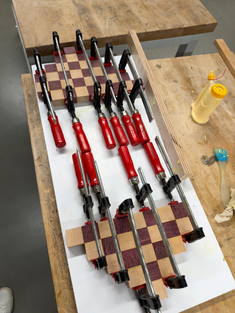 Two sub-assemblies clamped with F-clamps on melamine