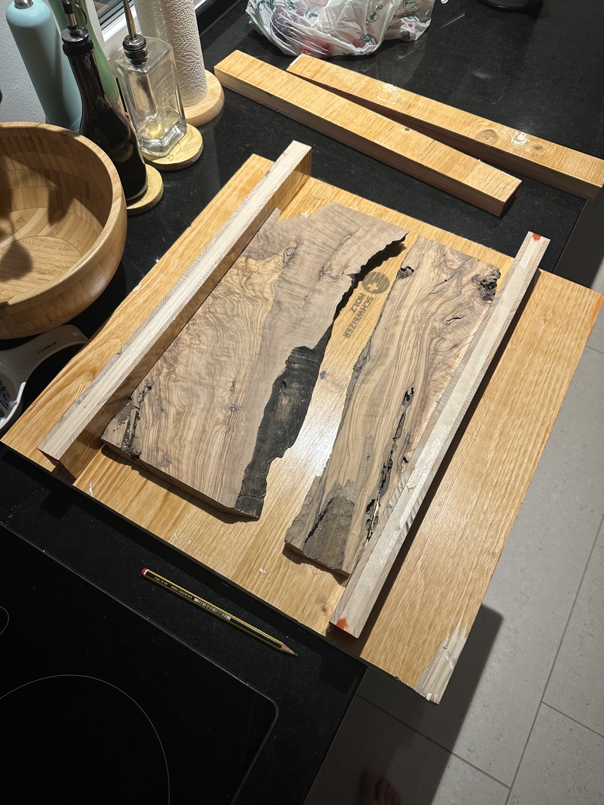 Raw Mediterranean olive wood slabs on workbench