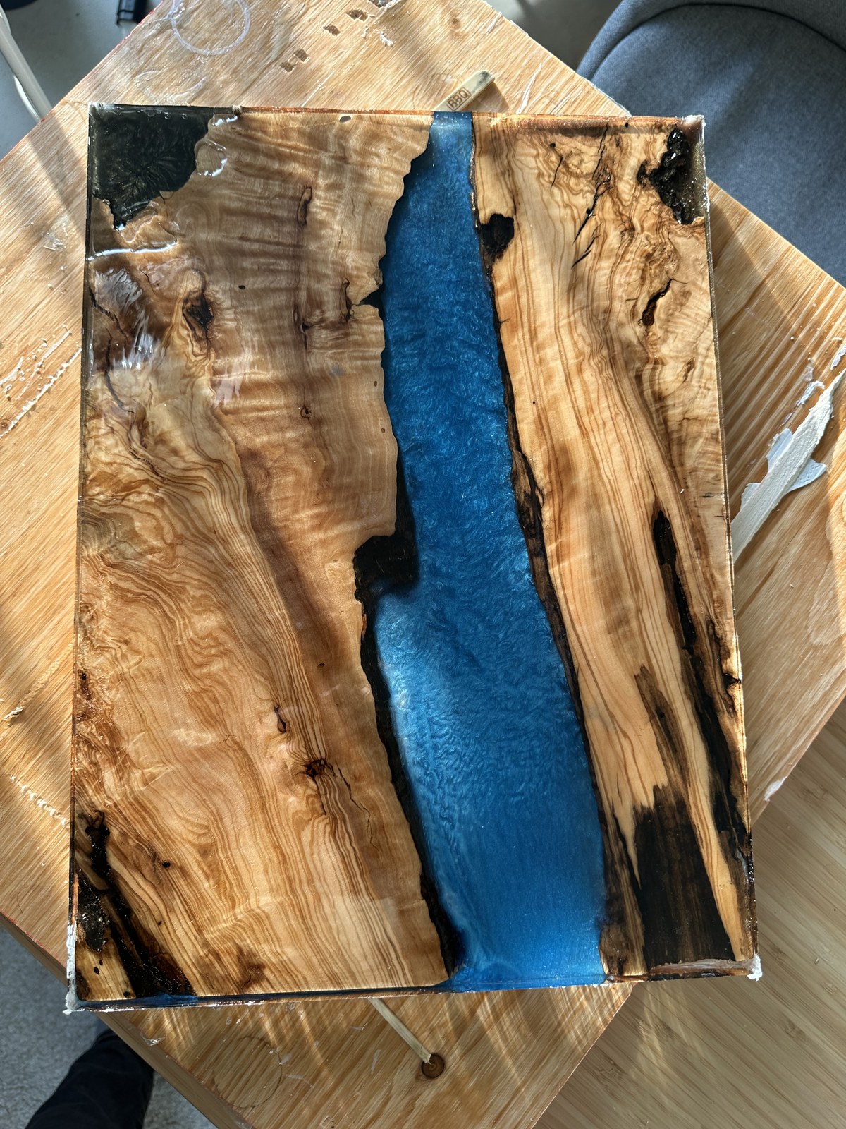 Rough surfaced olive and epoxy slab before polishing