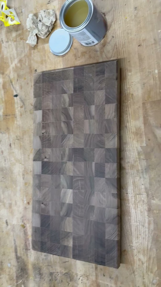 Raw dry sanded walnut end-grain board lying on workbench with finish can