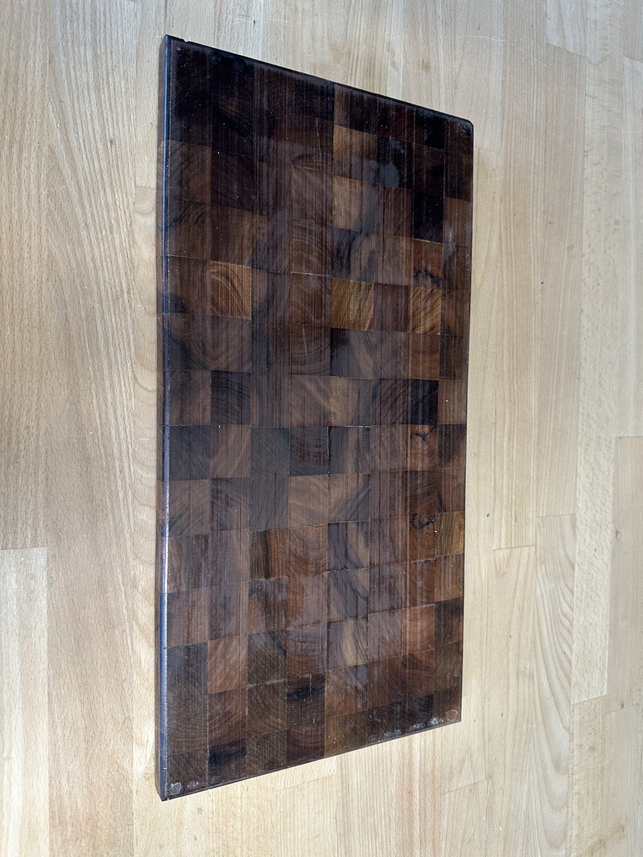 Deeply oiled and finished walnut end-grain cutting board standing upright